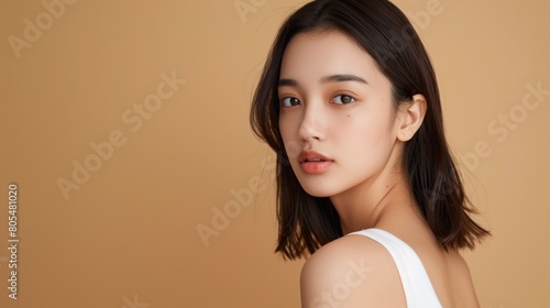 Elegant Asian Woman in Beige, with copyspace
