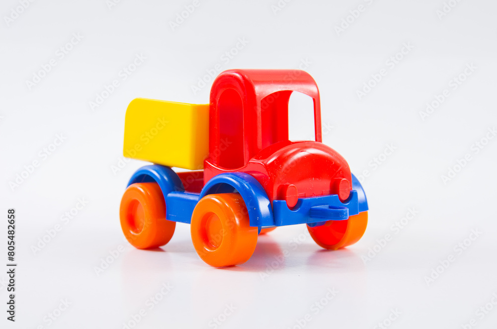Plastic toy multi-colored truck on a white background. Plastic toy multi-colored truck on a white background.