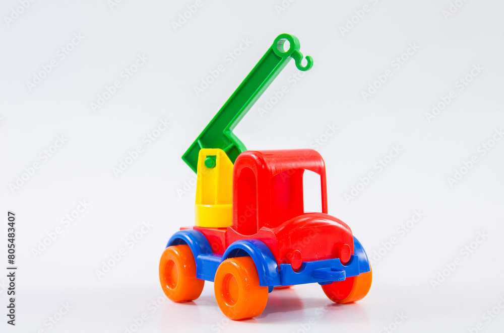 Plastic toy multi-colored truck on a white background. Plastic toy multi-colored truck on a white background.