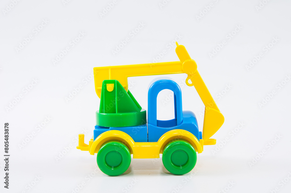 Plastic toy multi-colored truck on a white background. Plastic toy multi-colored truck on a white background.