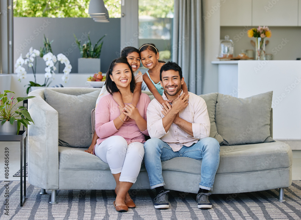 Hug, happiness and portrait of family on sofa in living room for care, love and bonding together in home. Smile, parents and girl children on couch for relax, having fun or weekend break in house Hug, happiness and portrait of family on sofa in living room for care, love and bonding together in home. Smile, parents and girl children on couch for relax, having fun or weekend break in house