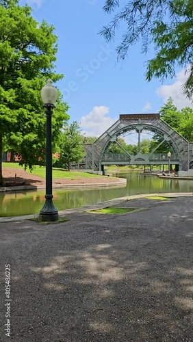 panning footage of a gorgeous spring landscape at Louis Armstrong Park with lush green trees and grass, a lake, blue sky and clouds in New Orleans Louisiana USA photo