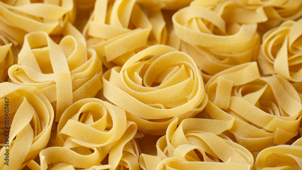 Heap of raw Italian pasta fettuccine Heap of raw Italian pasta fettuccine