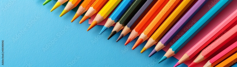 Colorful paper and pencils on bright vivid background with copy space Colorful paper and pencils on bright vivid background with copy space