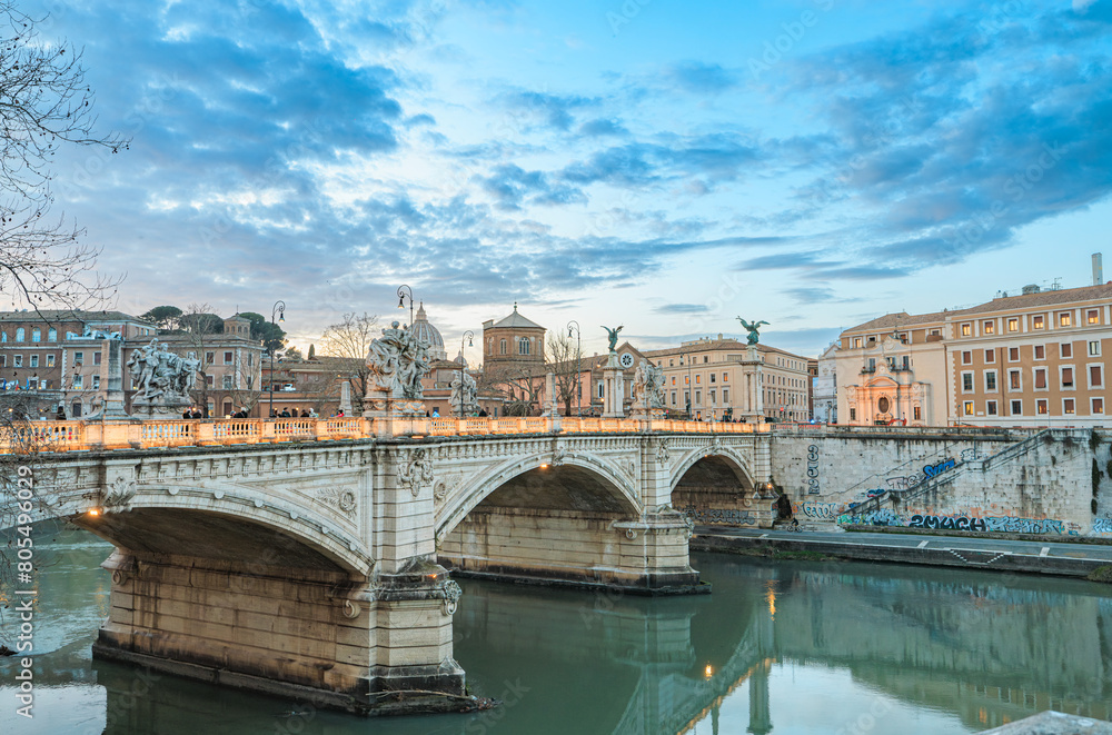 A majestic bridge spans across a serene river, with tall buildings towering in the background. The scene captures the harmony between nature and urban architecture A majestic bridge spans across a serene river, with tall buildings towering in the background. The scene captures the harmony between nature and urban architecture
