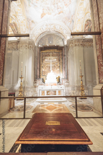 Within the expansive room  a grand wooden table stands as the centerpiece  exuding elegance and strength. The rooms vastness enhances the tables presence  inviting awe and curiosity