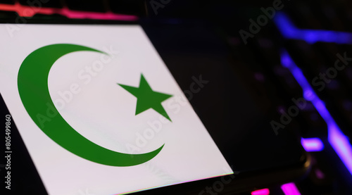 Canvas Print Crescent moon and star islam symbol on smartphone screen with computer keyboard