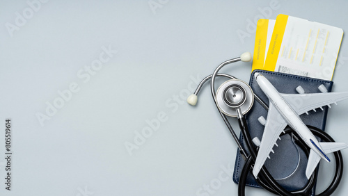 Foto Flat lay of travel insurance with passport, boarding passes, airplane and stethoscope with copy space