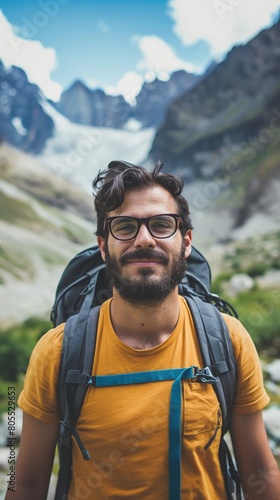Bearded man with glasses hiking with backpack