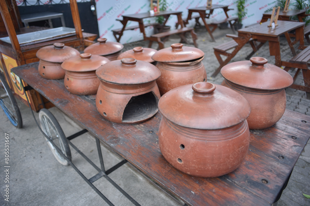 A collection of clay ceramic cooking stoves as decoration in front of a local restaurant A collection of clay ceramic cooking stoves as decoration in front of a local restaurant