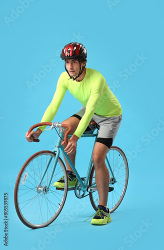 Young male cyclist riding b...