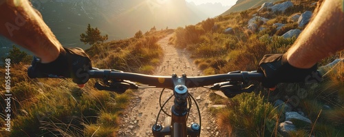 A view of the rider on the bicycle in the beutiful moutain path vwith sunset and nice landscape views.