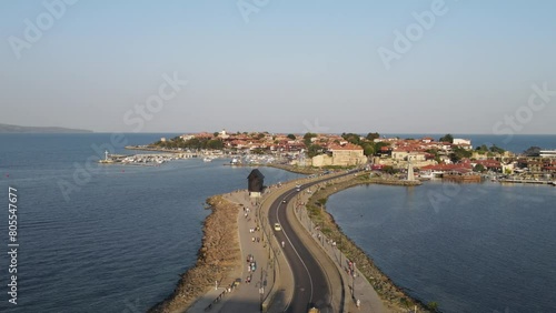 Bridge to Old Town of Nessebar, windmill and lanterns, road, landscape  Beautiful historical town Nessebar in Bulgaria. Drone view photo