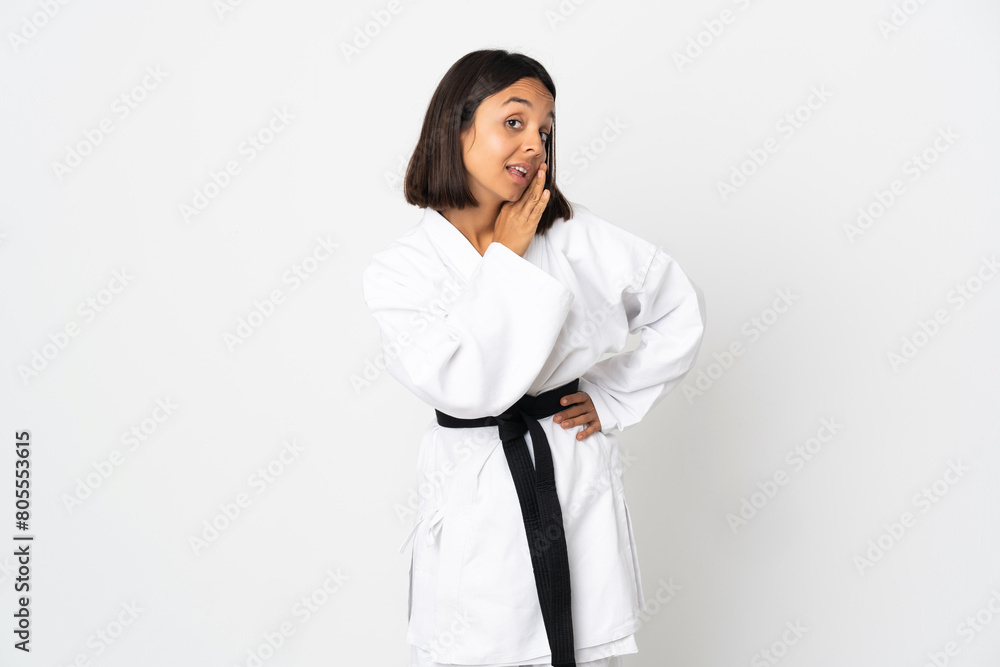 Young latin woman isolated on white background whispering something Young latin woman isolated on white background whispering something