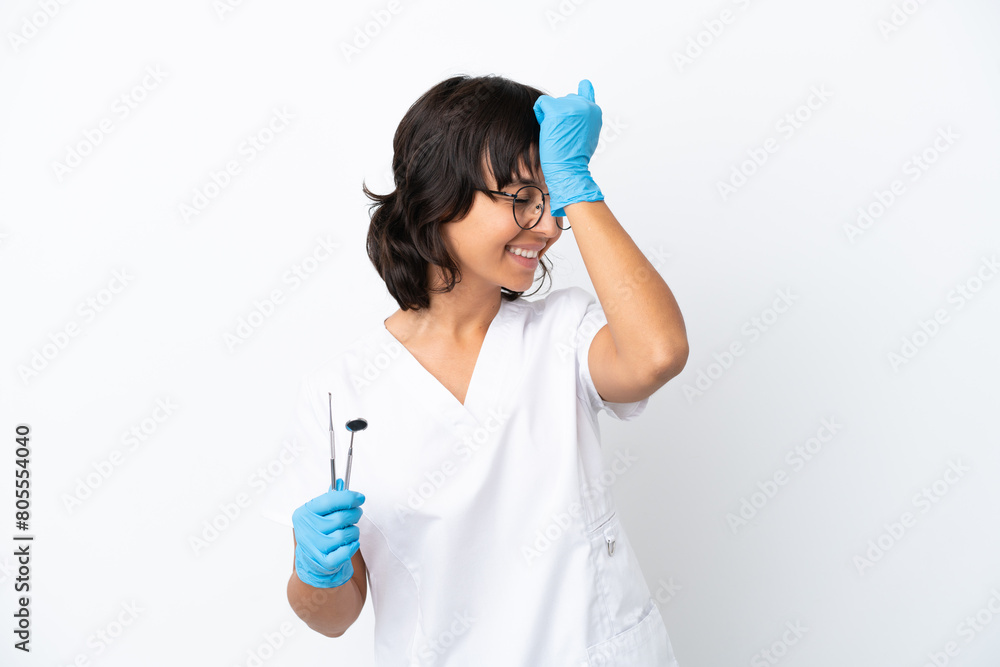 Young woman holding tools isolated on white background has realized something and intending the solution Young woman holding tools isolated on white background has realized something and intending the solution