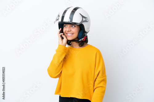 Woman with a motorcycle helmet keeping a conversation with the mobile phone © luismolinero