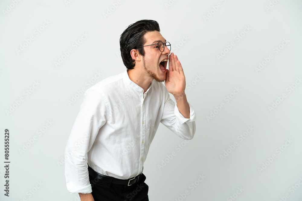 Russian Business man isolated on white background shouting with mouth wide open to the side Russian Business man isolated on white background shouting with mouth wide open to the side