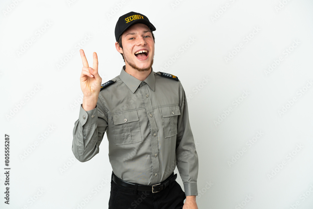 Young Russian security man isolated on white background smiling and showing victory sign Young Russian security man isolated on white background smiling and showing victory sign