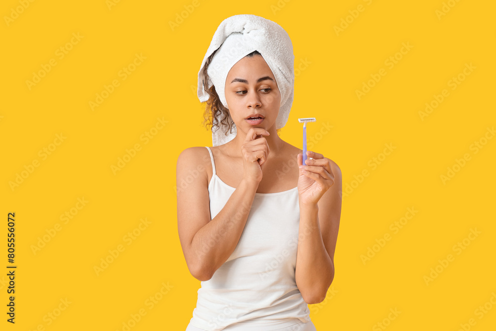 Beautiful young shocked woman with razor on yellow background. Depilation concept Beautiful young shocked woman with razor on yellow background. Depilation concept