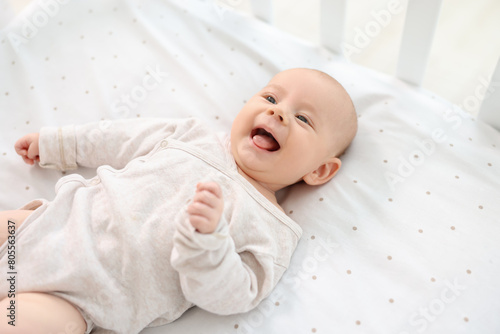 Cute little baby lying in crib at home