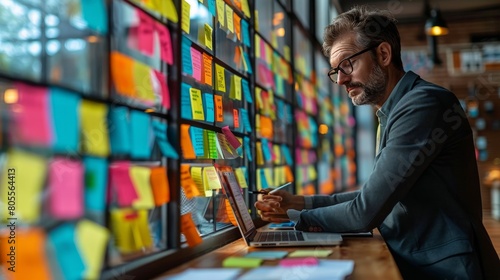 Man Sitting at Desk Using Laptop Computer