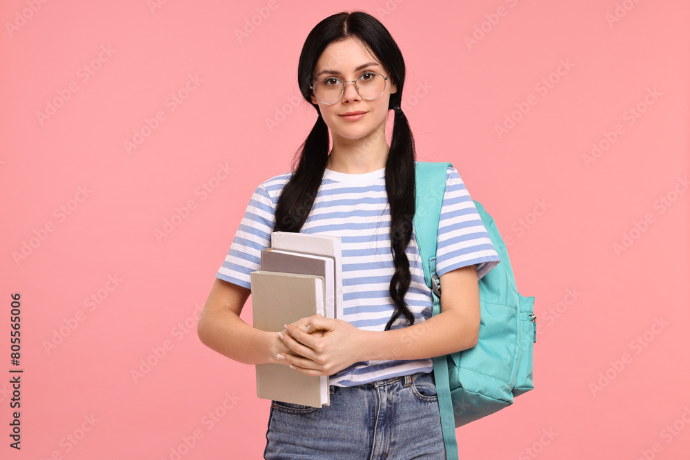 Student with books and backpack on pink background Student with books and backpack on pink background