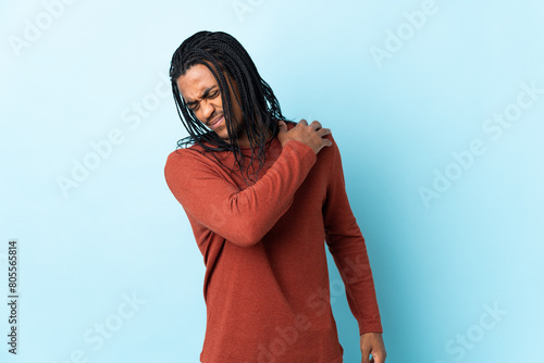 Delivery African American man with braids isolated on white background suffering from pain in shoulder for having made an effort