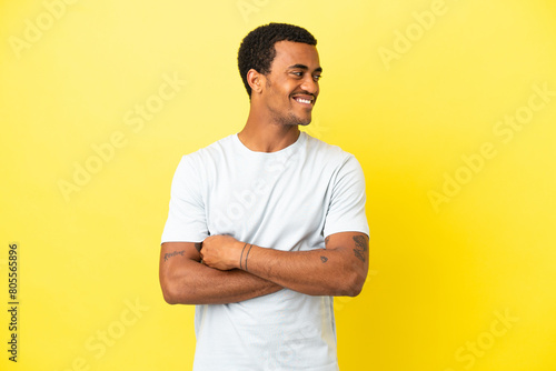 African American handsome man on isolated yellow background happy and smiling © luismolinero
