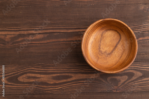 Wallpaper Mural Empty brown wooden bowl on brown wooden. Top view, copy space Torontodigital.ca