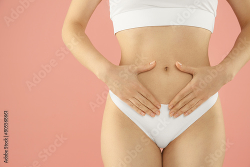 Gynecology. Woman in underwear on pink background, closeup. Space for text © New Africa