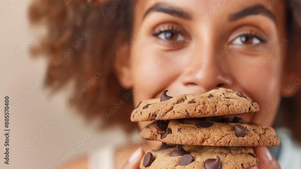 A Black woman enjoying a chocolate chip cookie A Black woman enjoying a chocolate chip cookie