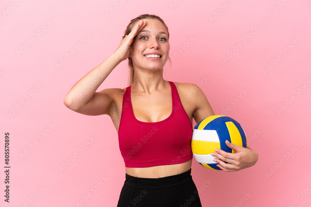 Young caucasian woman playing volleyball isolated on pink background with surprise expression Young caucasian woman playing volleyball isolated on pink background with surprise expression