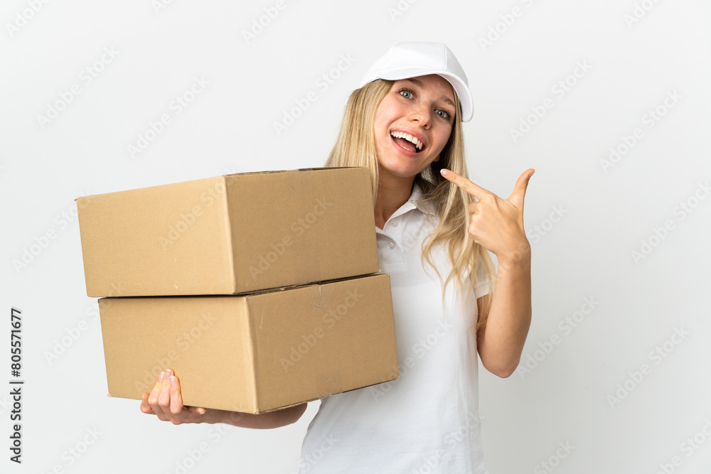 ¬°Young delivery woman isolated on white background giving a thumbs up gesture ¬°Young delivery woman isolated on white background giving a thumbs up gesture