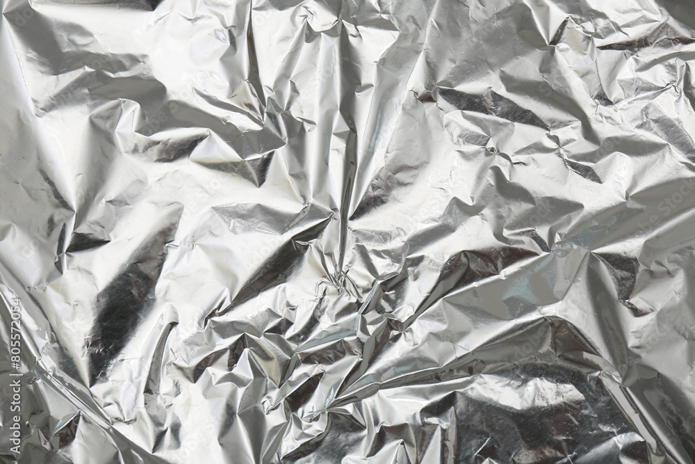 Crumpled silver foil as background, top view Crumpled silver foil as background, top view