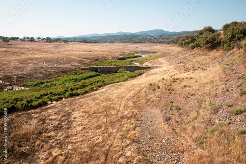 an old stone bridge over Rivera de Huelva at the reservoir of Aracena in Corteconcepcion, Sierra de Aracena natural park, province of Huelva, Andalusia, Spain