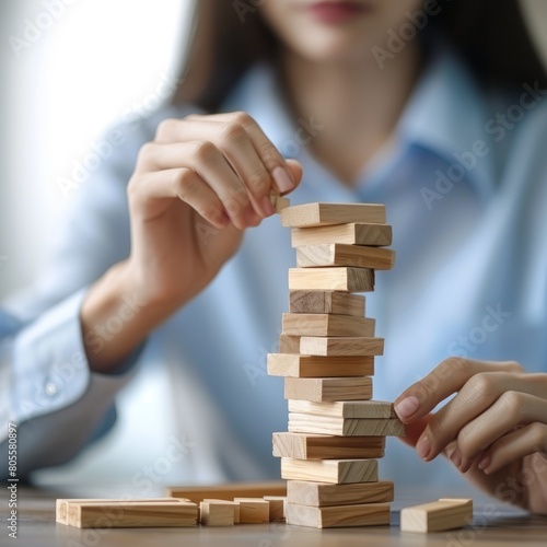 Businesswoman Strategically Maneuvering Wooden Blocks for Risk Management and Business Planning