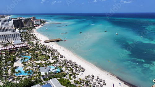 Palm Beach At Oranjestad In Caribbean Netherlands Aruba. Caribbean Beach. Blue Sea Background. Oranjestad At Caribbean Netherlands Aruba. Tourism Landscape. Nature Seascape.