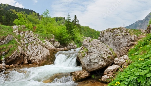 mountain stream flowing thorugh the rocks photo