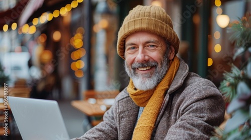 Man Sitting at Table Using Laptop Computer