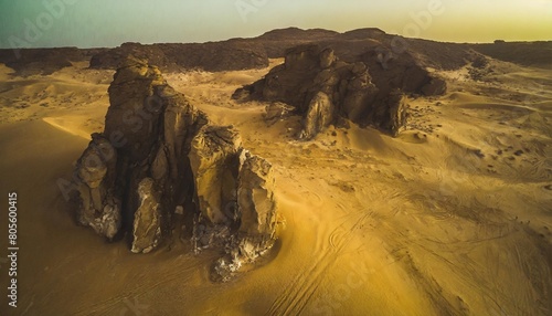 aerial view of rock formations among sand dunes at sunset in the sahara desert djanet algeria africa