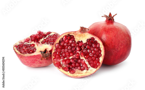 Halves and whole pomegranates isolated on white
