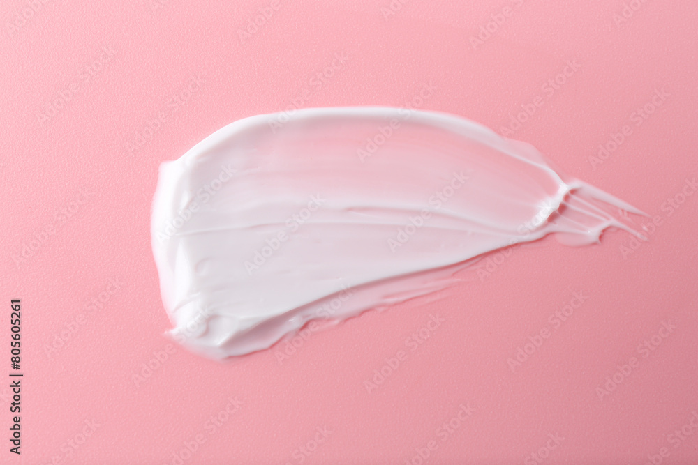 Sample of body care cream on pink background, top view