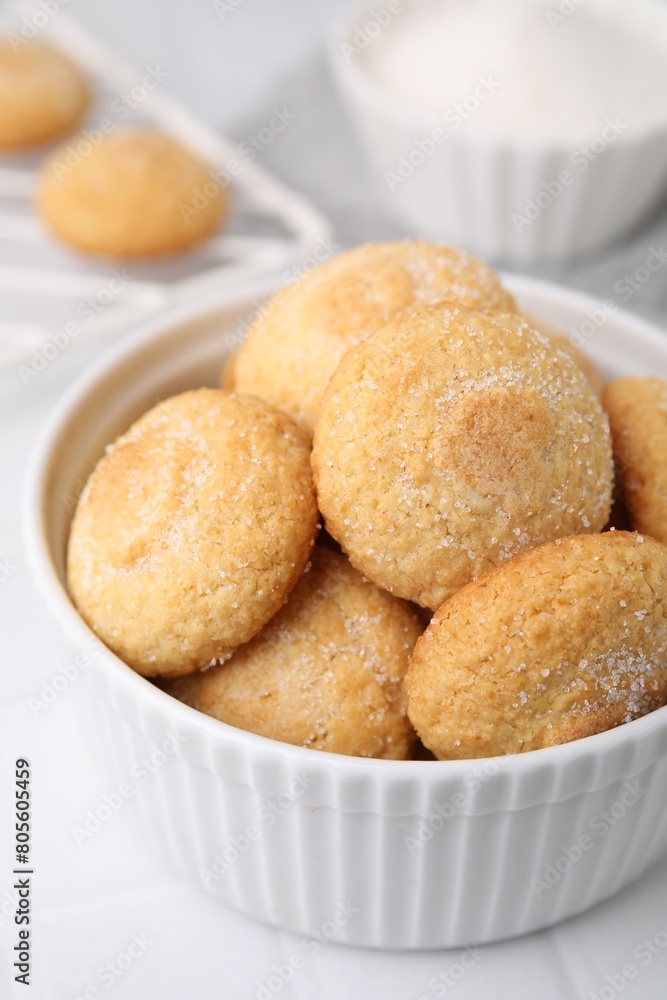 Tasty sugar cookies in bowl on white tiled table, closeup Tasty sugar cookies in bowl on white tiled table, closeup