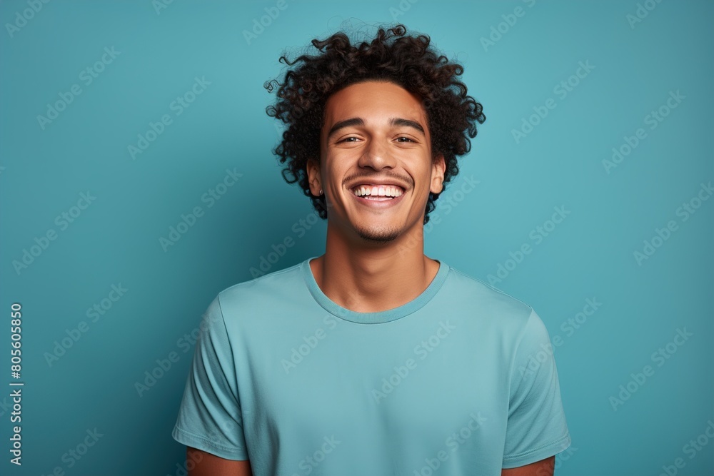 A man with curly hair is smiling and wearing a blue shirt A man with curly hair is smiling and wearing a blue shirt
