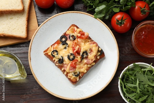 Tasty pizza toast and ingredients on wooden table, flat lay