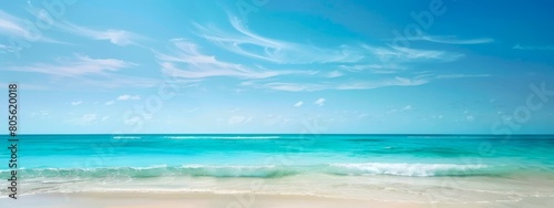 Tranquil beach with turquoise waves and clouds. Calm seashore with blue sky and clear waters. Concept of nature, relaxation, tropical destinations, vacation. Wide banner. Copy space