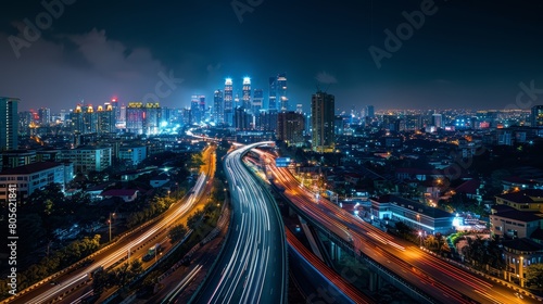 Night cityscape with light trails on highways in modern urban setting.