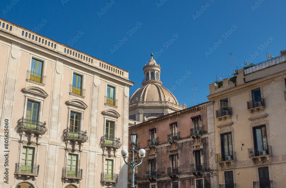 Piazza Universita in historic part of Catania city on the island of Sicily, Italy. View with Dome of Church of the Abbey of Saint Agatha