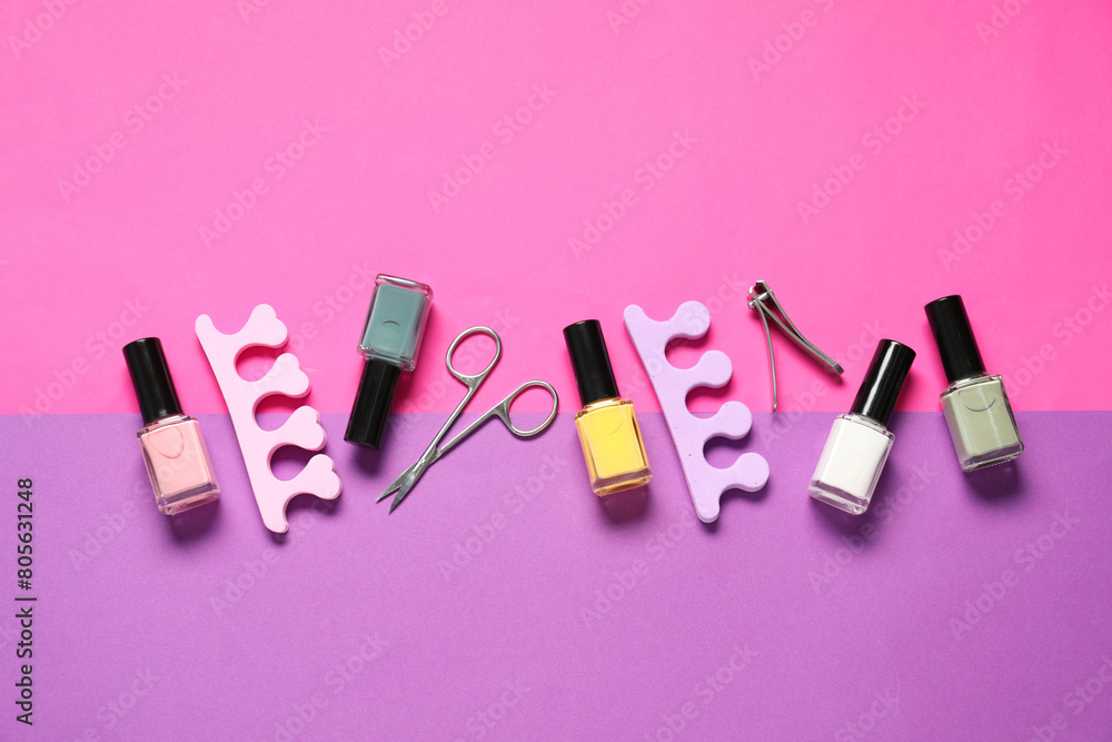 Nail polishes, clippers, scissors and toe separators on color background, flat lay Nail polishes, clippers, scissors and toe separators on color background, flat lay