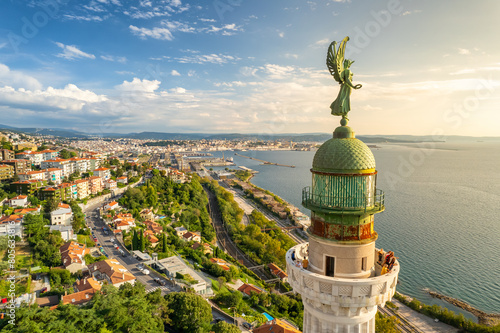 Faro della Vittoria lighthouse in Trieste city at sunny day, Italy photo